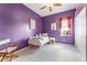 bedroom with purple walls, a small window with pink curtains, and ceiling fan at 739 Spring Island Way, Orlando, FL 32828