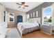 Stylish bedroom features decorative wallpaper, wood floors, ceiling fan, and bright, natural light at 739 Spring Island Way, Orlando, FL 32828