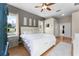 Spacious bedroom with natural light, ceiling fan, and patterned accent wall and hardwood flooring at 739 Spring Island Way, Orlando, FL 32828