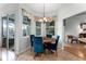 Dining room with a round wood table, blue velvet chairs, and a large window overlooking the backyard at 739 Spring Island Way, Orlando, FL 32828