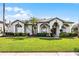 Inviting single-story home with manicured lawn, arched windows, and stately columns at 739 Spring Island Way, Orlando, FL 32828