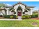 Charming home showcasing a lush green lawn and a welcoming front entrance with unique door at 739 Spring Island Way, Orlando, FL 32828