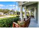 Relaxing front porch featuring a swing and views of the landscaped yard at 739 Spring Island Way, Orlando, FL 32828