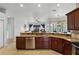 Open kitchen featuring stainless steel appliances, granite countertops, and a view into the living area at 739 Spring Island Way, Orlando, FL 32828