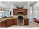 Stylish kitchen with stainless steel appliances, dark cabinetry, and a view of the dining area at 739 Spring Island Way, Orlando, FL 32828