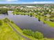 Aerial view of a beautiful lake with a walking path surrounded by lush greenery and landscaping at 739 Spring Island Way, Orlando, FL 32828