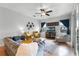 Comfortable living room featuring a ceiling fan, plush seating, and abundant natural light at 739 Spring Island Way, Orlando, FL 32828