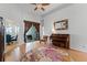 Open-concept living room featuring wood floors, a piano, and access to the dining area and outdoor space at 739 Spring Island Way, Orlando, FL 32828