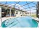 Beautiful pool with a water feature within a screened enclosure, complete with string lights for serene outdoor enjoyment at 739 Spring Island Way, Orlando, FL 32828