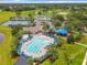 Community recreation center aerial view with swimming pool, tennis courts, and playground for residents at 739 Spring Island Way, Orlando, FL 32828