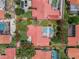 Aerial shot of home with screened pool, lush backyard landscaping, and terra cotta roof at 8012 S Madeira Ct, Orlando, FL 32836