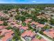 Enjoy suburban living with a private screened-in pool, and lush surroundings in this aerial neighborhood view at 8012 S Madeira Ct, Orlando, FL 32836