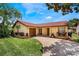 Charming one-story home with well-maintained landscaping, a red tile roof, and a private two-car garage at 8012 S Madeira Ct, Orlando, FL 32836