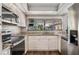 Well-lit kitchen features stainless steel appliances, granite countertops, and modern white cabinetry for a sleek design at 8012 S Madeira Ct, Orlando, FL 32836