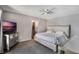 Bedroom featuring a tufted headboard bed, mirrored nightstand, and ensuite bathroom at 8012 S Madeira Ct, Orlando, FL 32836