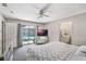 Bedroom featuring a large bed and sliding glass doors providing a view of the pool at 8012 S Madeira Ct, Orlando, FL 32836