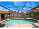 Relaxing pool with a screened enclosure, a large patio area, and landscaped surroundings at 8012 S Madeira Ct, Orlando, FL 32836