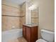 Bathroom featuring a large bathtub with tile surround and a classic vanity at 8323 Bella Vida Cir, Davenport, FL 33896