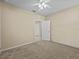 Neutral bedroom featuring a ceiling fan, with an entrance to an ensuite bathroom and closet at 8323 Bella Vida Cir, Davenport, FL 33896