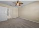 Bright bedroom showcasing an ensuite bathroom, door and neutral tones for a serene living experience at 8323 Bella Vida Cir, Davenport, FL 33896