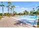 Expansive community pool area with ample seating, palm trees, and resort-style amenities at 8323 Bella Vida Cir, Davenport, FL 33896