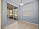 Bright dining area features tiled floor, a modern light fixture, and sliding glass door access at 8323 Bella Vida Cir, Davenport, FL 33896