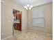 Inviting dining area with tile flooring, a modern chandelier, and views of the kitchen at 8323 Bella Vida Cir, Davenport, FL 33896