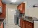 Kitchen featuring stainless steel appliances, granite counters, and open view into dining area at 8323 Bella Vida Cir, Davenport, FL 33896