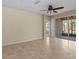 Living room featuring tile floors, ceiling fan, and a sliding glass door with lanai access at 8323 Bella Vida Cir, Davenport, FL 33896