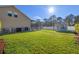 Expansive back yard featuring green grass and a storage shed, adjacent to a screened-in pool area at 8712 Irmastone Way, Orlando, FL 32817