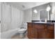 Cozy bathroom featuring a shower and bathtub combination with vanity and neutral fixtures at 8712 Irmastone Way, Orlando, FL 32817