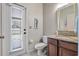 Bathroom with a decorative mirror, granite countertop and direct access to the backyard at 8712 Irmastone Way, Orlando, FL 32817