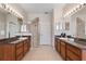 Spacious bathroom boasting dual sinks, dark wood cabinets, and a glass-enclosed shower with a neutral color palette at 8712 Irmastone Way, Orlando, FL 32817