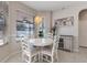 Bright breakfast nook with white table and chairs, natural light from the window, and modern decor at 8712 Irmastone Way, Orlando, FL 32817