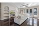 Stylish living room with hardwood floors, custom built-ins, a comfortable white sofa, and natural light at 8712 Irmastone Way, Orlando, FL 32817