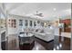 Bright and airy living room with hardwood floors, a white sectional, and large windows for natural light at 8712 Irmastone Way, Orlando, FL 32817