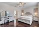 A beautiful main bedroom with a decorative bed frame and convenient vanity at 8712 Irmastone Way, Orlando, FL 32817