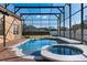 Sparkling pool and jacuzzi enclosed in a screened lanai, perfect for relaxation and entertainment at 8712 Irmastone Way, Orlando, FL 32817