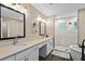 Modern bathroom featuring double vanity, decorative lighting, and walk-in shower at 909 E Central Blvd, Orlando, FL 32801