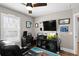 Bedroom features a recliner, a desk, a ceiling fan and is decorated with sports memorabilia at 909 E Central Blvd, Orlando, FL 32801