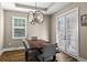 Elegant dining room featuring modern lighting, wood floors, and doors to the outside area at 909 E Central Blvd, Orlando, FL 32801