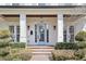 Charming front porch with brick steps, columns, and a light blue door, adding character to the entrance at 909 E Central Blvd, Orlando, FL 32801