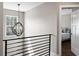 A naturally lit hallway features modern black metal railings and contemporary light fixtures, leading to a bedroom at 909 E Central Blvd, Orlando, FL 32801