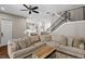 Inviting living room featuring a sectional sofa, ceiling fan, and view of the modern kitchen at 909 E Central Blvd, Orlando, FL 32801