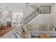 Open-concept living room featuring wood floors, a comfortable sofa, and a modern staircase with black metal railings at 909 E Central Blvd, Orlando, FL 32801