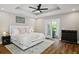 Relaxing main bedroom featuring tray ceiling, ceiling fan, and balcony access at 909 E Central Blvd, Orlando, FL 32801