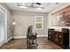 Cozy office with tray ceiling, hardwood floors, natural light, and a rustic cabinet at 909 E Central Blvd, Orlando, FL 32801