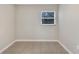 A bedroom with neutral walls and tile floors featuring a window at 913 Ferndell Rd, Orlando, FL 32808