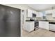 Well-lit kitchen featuring stainless steel appliances, white cabinets, and granite countertops at 913 Ferndell Rd, Orlando, FL 32808