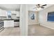 A view of the kitchen featuring stainless steel appliances and white cabinets, with a partial view of the living room at 913 Ferndell Rd, Orlando, FL 32808